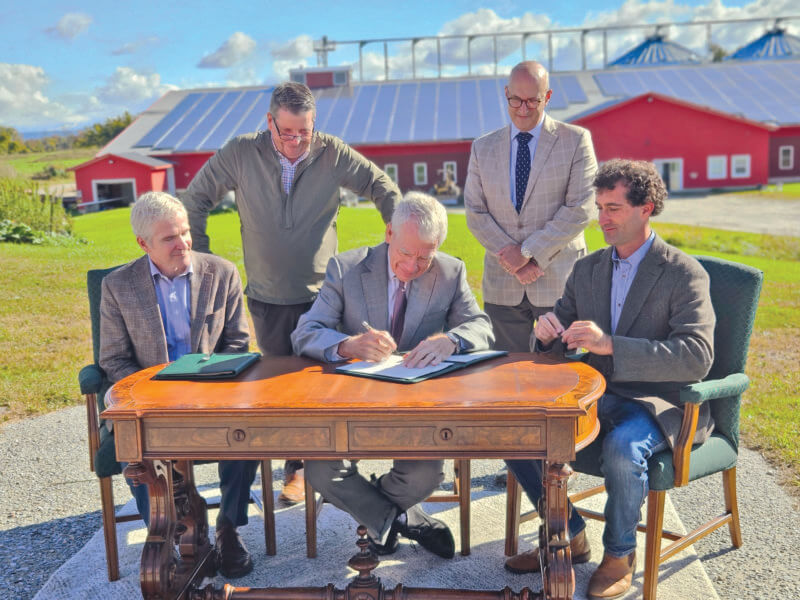 Photo by Joshua Defibaugh/University of Vermont Front from left, Christian Peters of the USDA, Richard Cate of the University of Vermont and Nordic farm owner Ben Dobson sign an agreement for the farm to lease around 400 acres for agricultural research, while Vermont Agriculture Secretary Anson Tebbetts and UVM Vice President for Research Kirk Dombrowski watch the historic agreement.