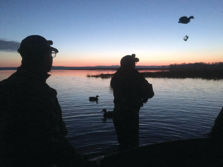 Preparing for duck hunting in a cold, dark wind before dawn