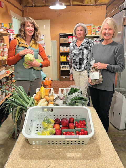 Photo by Peggy Sharpe From left, Meaghin Kennedy, owner of Frog Song Farm, delivers fresh produce to volunteers Sis Capeless and Janet Landrigan. Frog Song Farm was the food shelf’s partner for produce as part of a Vermonters Feeding Vermonters grant.